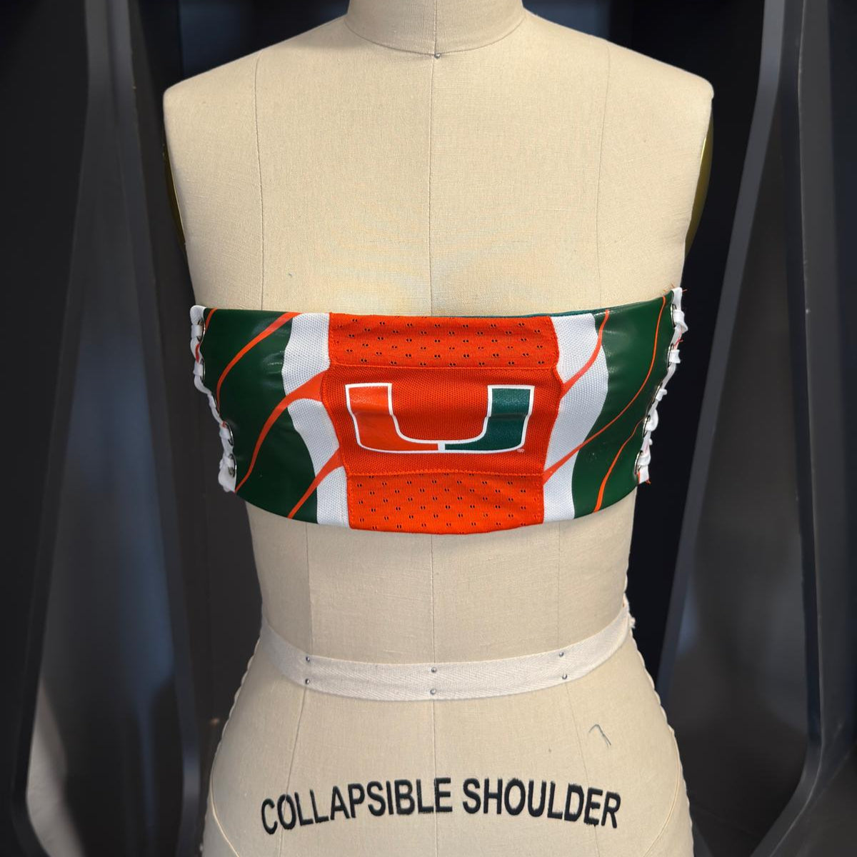 Reworked University of Miami tube top made from jersey fabric with lace-up elastic sides, size S/M