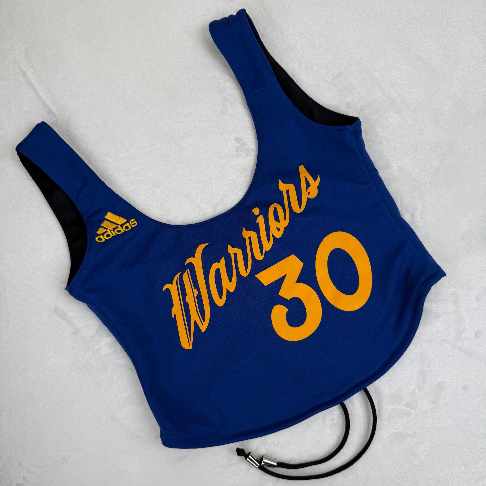 Golden State Warriors women’s crop top featuring bold team branding, vintage-inspired design, and sustainable materials, perfect for eco-conscious basketball fans.