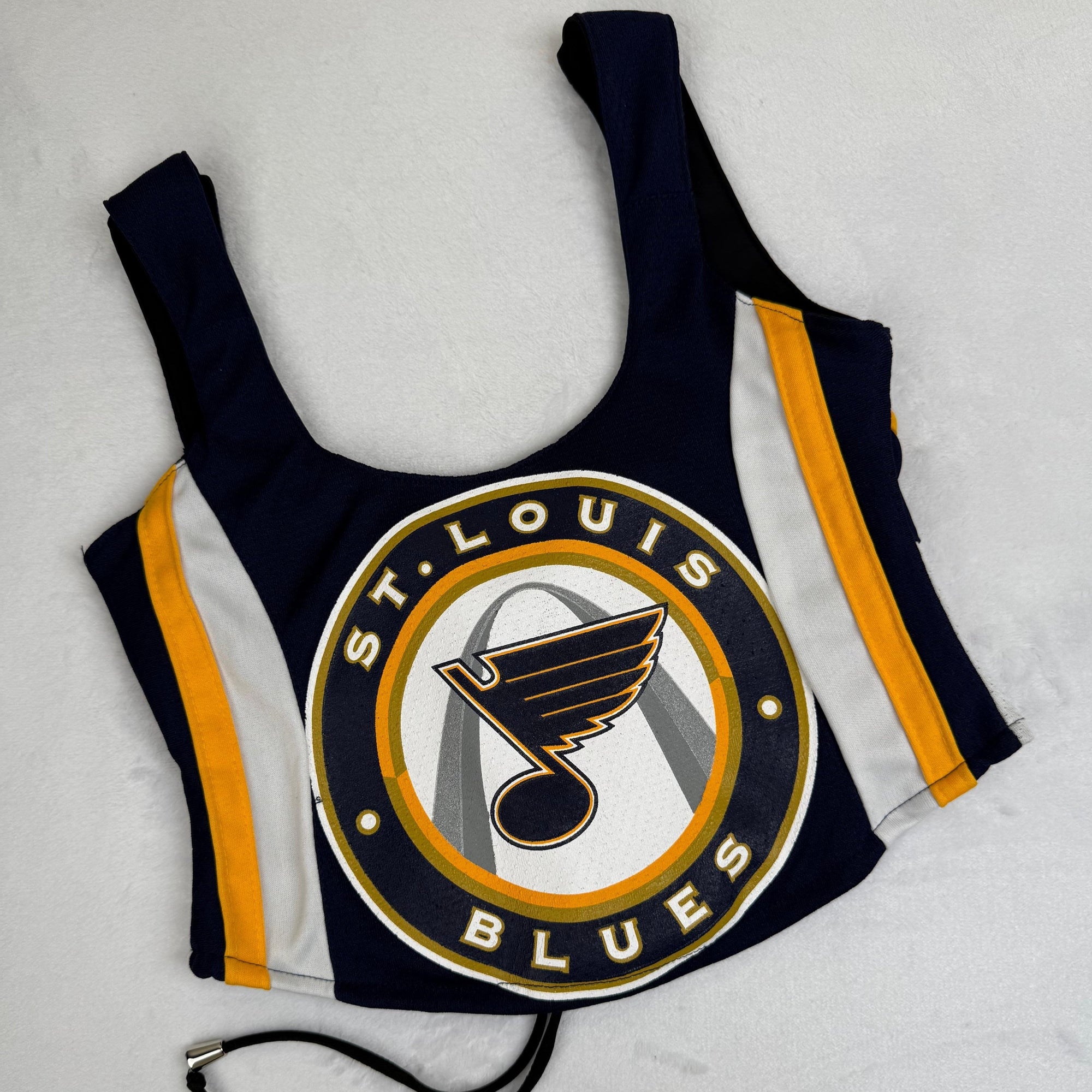 St. Louis Blues tank top with bold team branding, a sporty crop design, and a sustainable, upcycled fabric for fans seeking eco-friendly fashion.