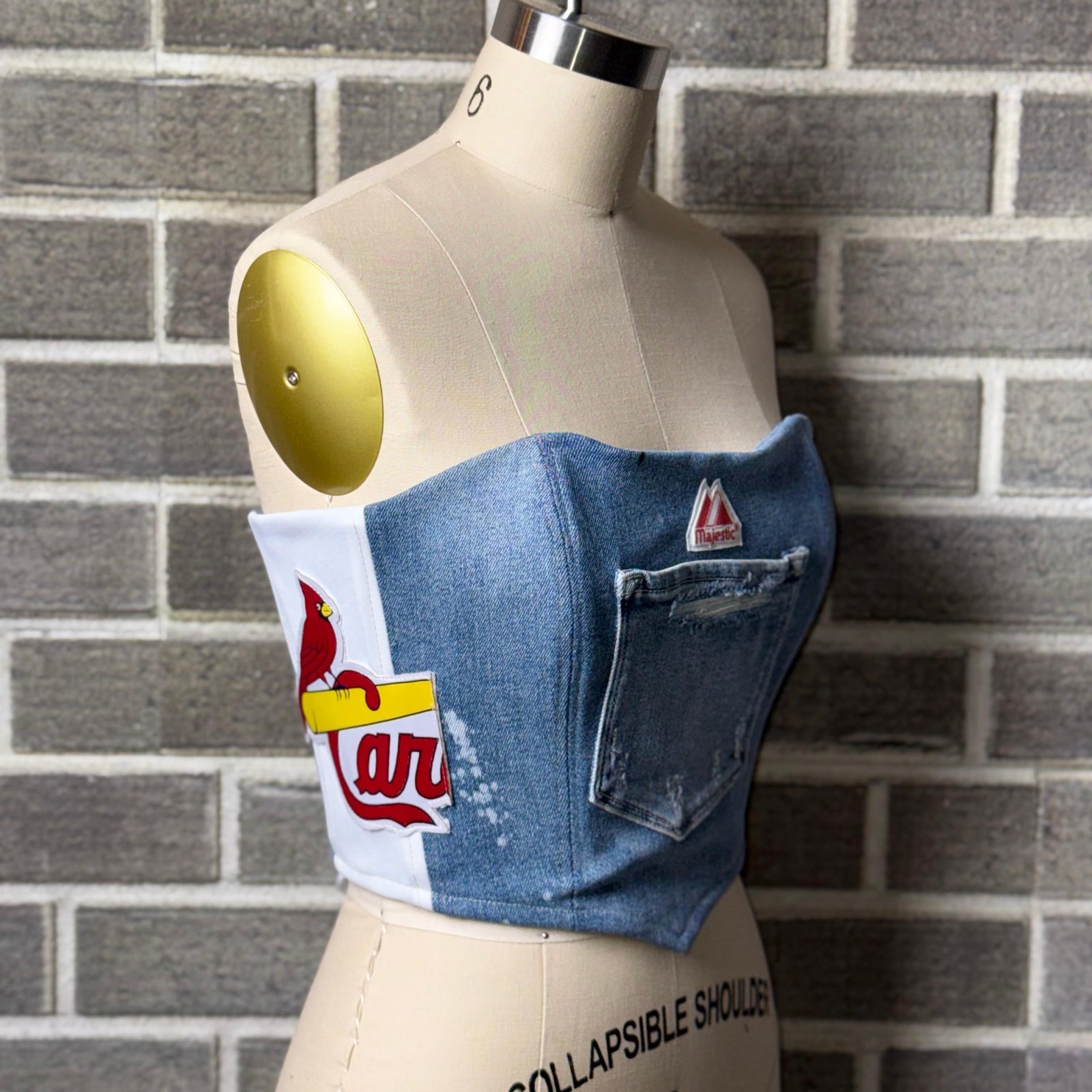 Revamped Cardinals corset top with denim and Majestic patch, perfect for women’s Cardinals apparel fans